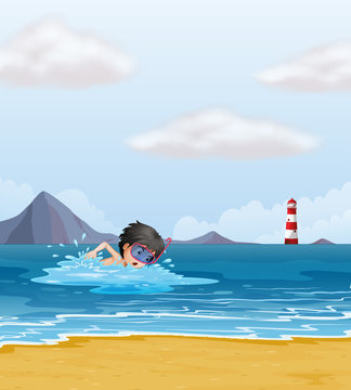 A boy swimming in the sea near the lighthouse