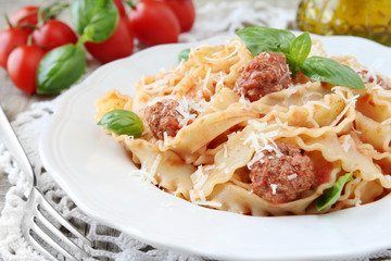 Reginette or mafaldine pasta with meatball tomato sauce