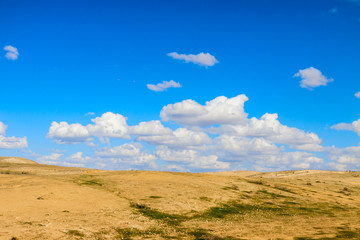 Fototapeta na wymiar Sky with small clouds over a desert