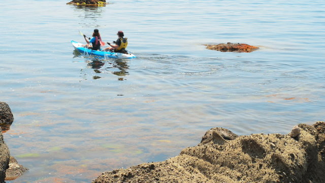 traveler kayaking in the Black sea from backward view