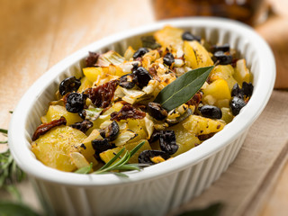 baked potatoes with dried tomatoes and black olives
