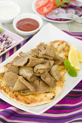Donner Meat on Naan - Slices of donner meat on a flatbread