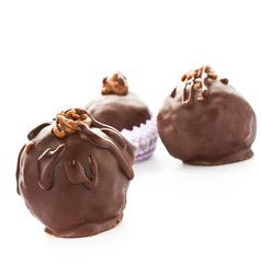 Three delicious  dark chocolate candies isolated on a white back