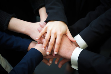 Businesspeople putting their hands together