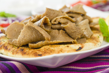 Donner Meat on Naan - Slices of donner meat on a flatbread