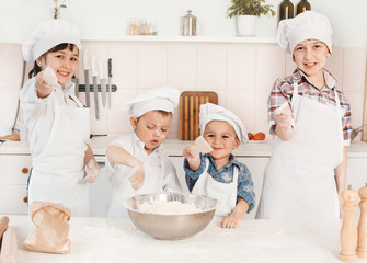 happy little chefs preparing dough in the kitchen