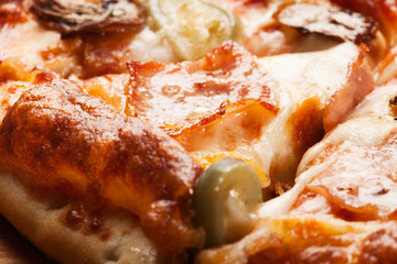 Closeup of pizza with ham, cheese and mushroom