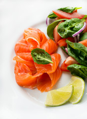 Salted salmon with fresh green salad and lime