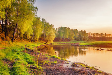 Summer sunset around field and river