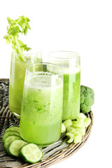 Glasses of green vegetable juice, isolated on white