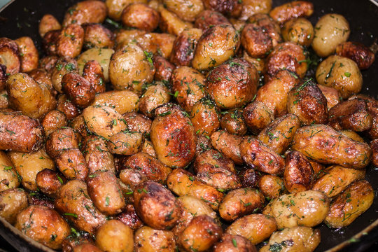 Baby skinned potatoes on pan with dill and fried