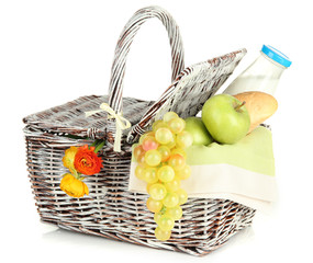 Picnic basket with fruits and bottle of milk, isolated on white