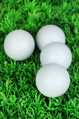 Golf balls on grass close up