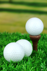 Golf balls on grass outdoor close up