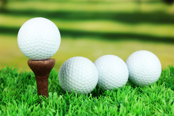 Golf balls on grass outdoor close up