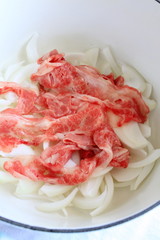 onion and beef in pan for cooking image