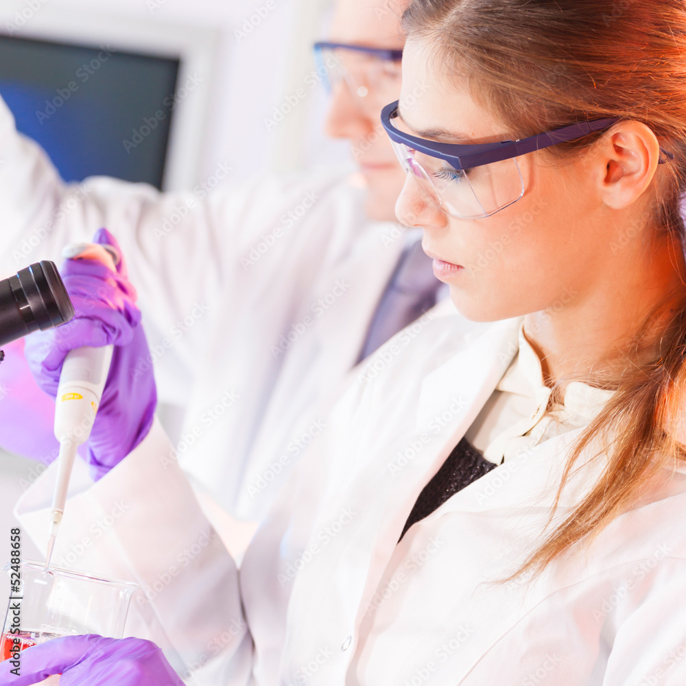 Poster young scientist pipetting red solution.