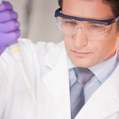 Researcher pipetting in the laboratory.
