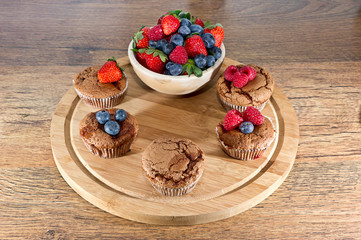 mixed muffins fruits on wooden board