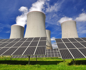 Solar energy panels before a nuclear power plant