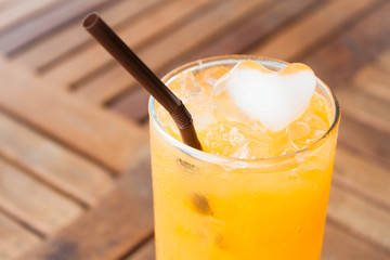 Heart cube ice of fresh orange juice