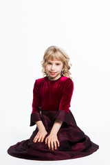 small and beautiful girl in a red dress