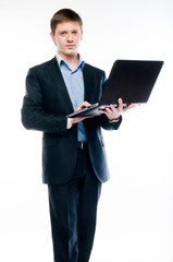 A young and successful business man in a dark business suit