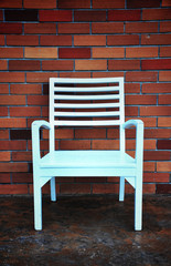 Fototapeta na wymiar chairs with beautiful red brick wall background