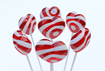 Red-white lollipops in the shape of heart