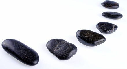 black zen stones on white background, soft shadows