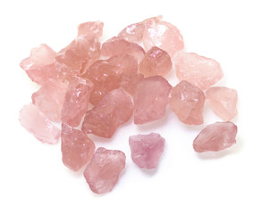 Raw rose quartz gemstones isolated on white background.