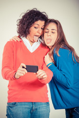 Two Beautiful Women Taking Self Portrait with Mobile Phone