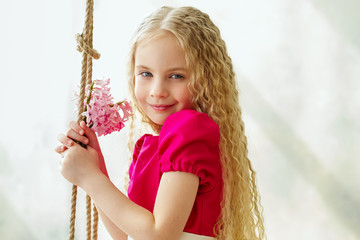 Portrait of an adorable girl with pink flowers