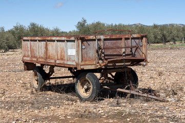 Old farm trailer on a fallow field