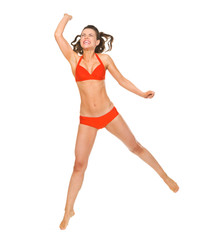 Young woman in swimsuit playing beach volleyball