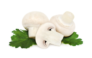 Three champignons on green leaves (isolated)