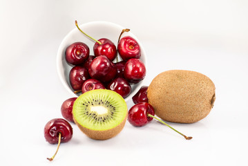 Cherrys and kiwi fruits on the white background