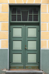 Obraz na płótnie Canvas Green door in old building facade. Tallinn, Estonia