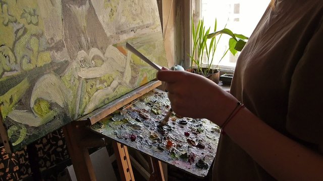 Woman painting picture.