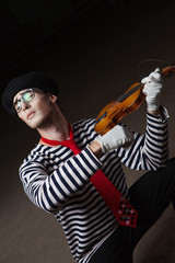 Portrait of a mime playing the violin