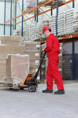 worker with  pallet jack in warehouse