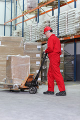 worker with  pallet jack in warehouse © endostock