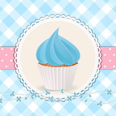 cupcake with blue icing on blue gingham background