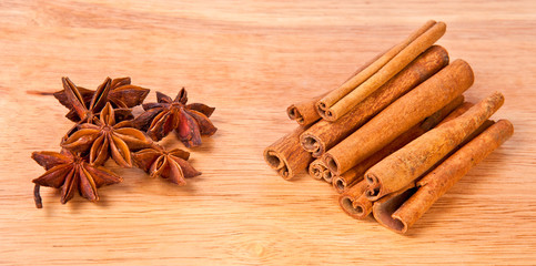Cinnamon and anise on a wooden background