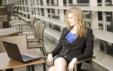 Young bussines woman with modern office in her background