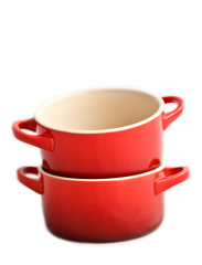 Two red cocottes  without covers on a white background