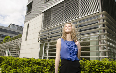 Young bussines woman with modern office in her background