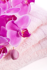 Fototapeta na wymiar luxury wellness towel with pink orchid flower