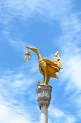 Fototapeta na wymiar Golden swan lamp on the blue sky