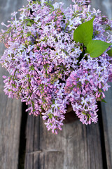 lilacs on wooden garden table